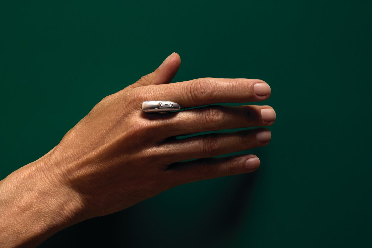 Phonak Audeo EON Sphere hearing aid held in a hand showing its compact size