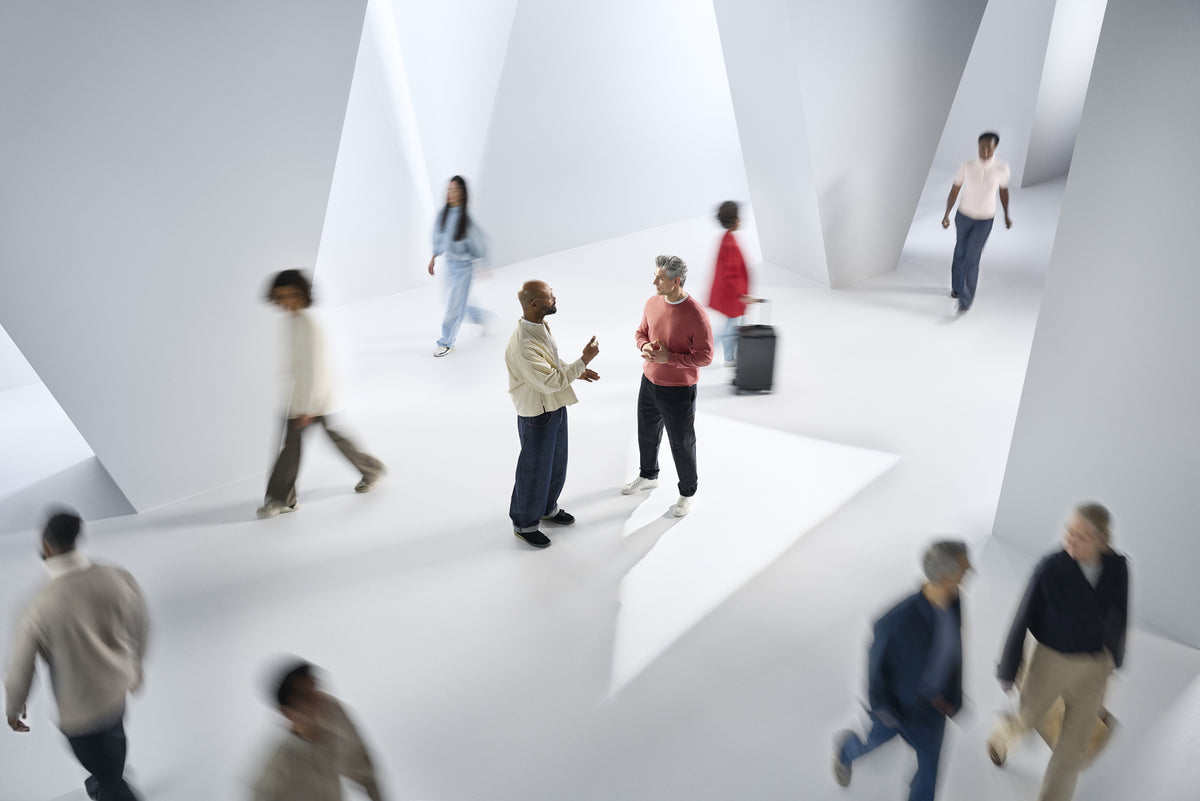 People talking in a busy public space in the ReSound Sensia campaign