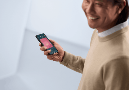 ReSound hearing aid wearer using a smartphone