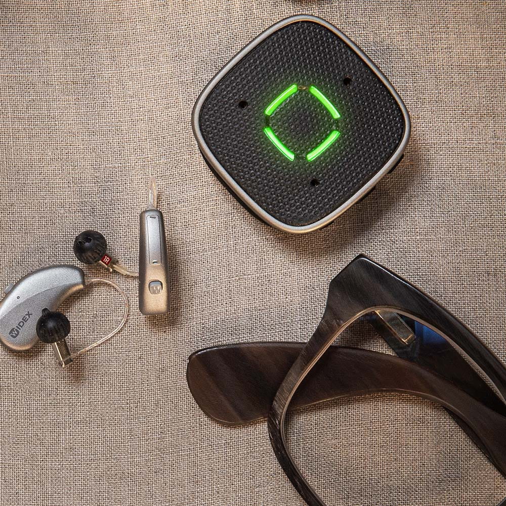 Widex Sound Assist accessory for Widex SmartRIC and Moment Sheer hearing aids, featuring a compact design with control buttons.