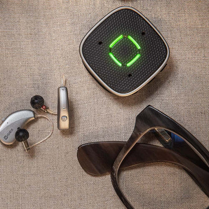 Widex Sound Assist accessory for Widex SmartRIC and Moment Sheer hearing aids, featuring a compact design with control buttons.