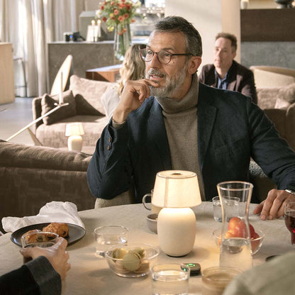 Widex Sound Assist accessory for Widex SmartRIC and Moment Sheer hearing aids, shown in a lifestyle setting.
