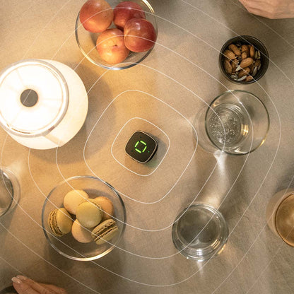 Widex Sound Assist accessory for Widex SmartRIC and Moment Sheer hearing aids, shown on a table with small electronic components.